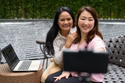 two mature asian women together outside the mall in bangkok city stock image image of