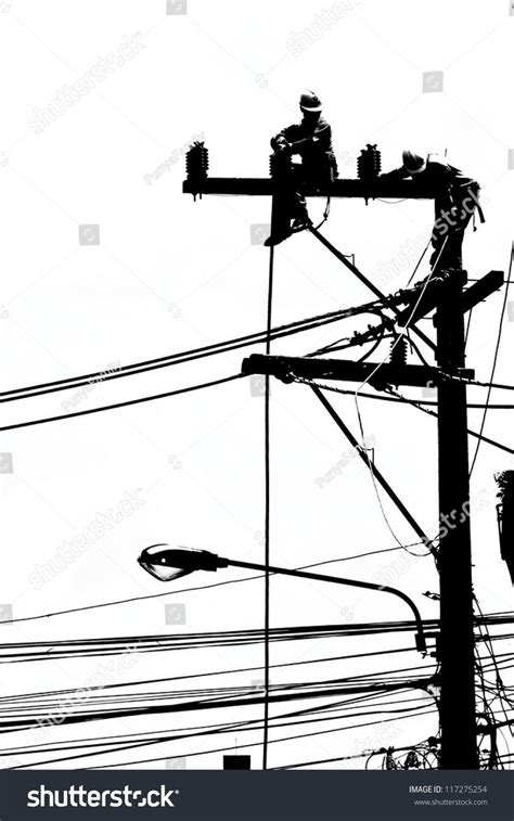 Silhouette Electrician Working On Electricity Post Stock Photo
