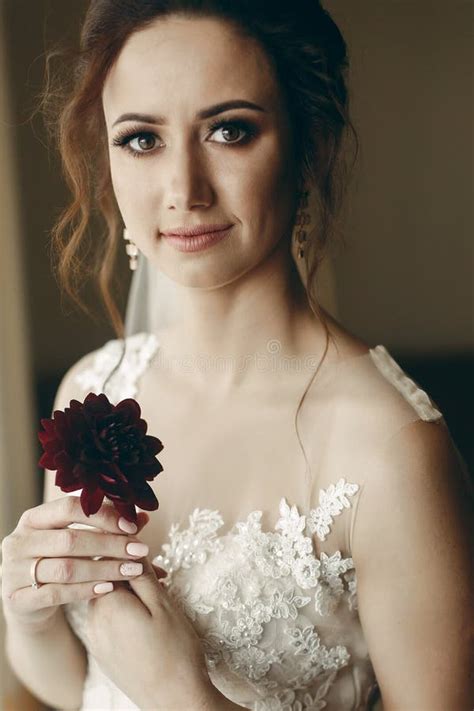 Gorgeous Bride In Vintage Lace White Wedding Dress Holding Red Flower