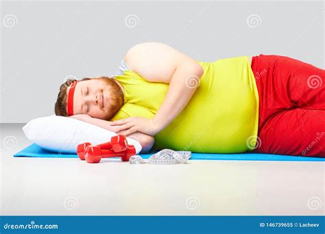 Lazy Fat Funny Man Is Sleeping On A Gray Background Stock Image