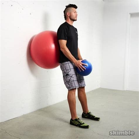 Wall Ball Squats With Ball Raises Exercise How To Workout Trainer