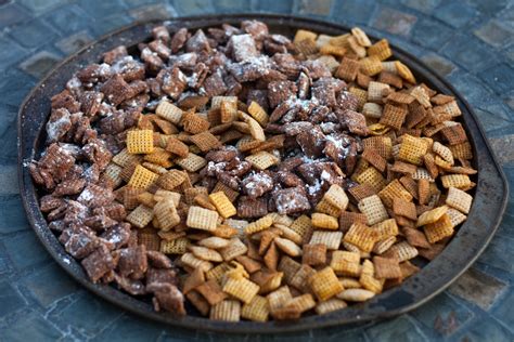 When shaking the cereal mixture with powdered sugar in a large plastic bag, add crushed oreo cookie pieces. puppy chow chex mix recipe