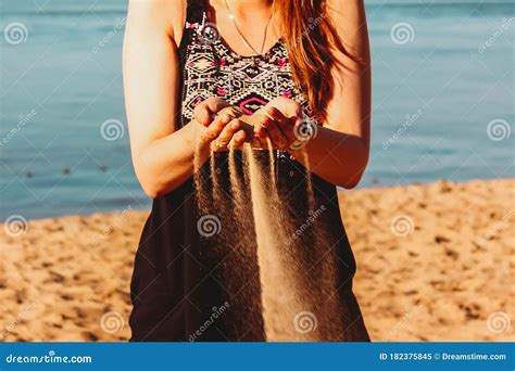 Woman Hands Holding And Spilling Sand On The Beachvery Shallow Depth