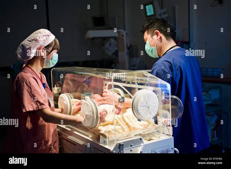 Doctor And Nurse Examining Newborn Baby In Incubator Stock Photo Alamy