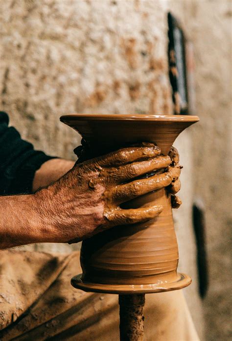 Man With Hands In Clay Making Vase On Pottery Wheel · Free Stock Photo