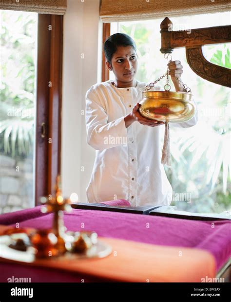 A Spa Therapist Prepares The Sariva Room For A Shirodhara Ayurvedic