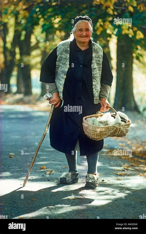 Old Italian Woman Walking Country Road With Basket Of Yarn To Village