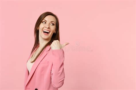 Portrait Of Laughing Funny Young Woman Wearing Jacket Looking Pointing Thumb Aside Isolated On