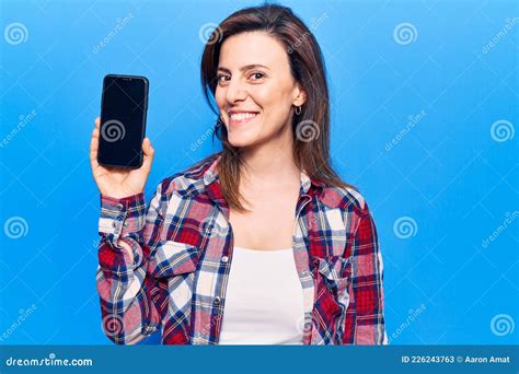 Young Beautiful Woman Holding Smartphone Showing Screen Looking