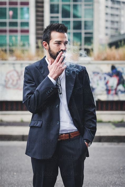 Businessman Smoking A Cigarette After A Stressful Business Day By Stocksy Contributor Mauro