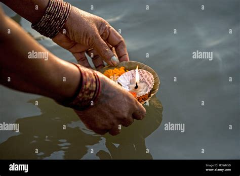 india varanasi ganga river ghats hindu pilgrim woman placing floating candles on ganges