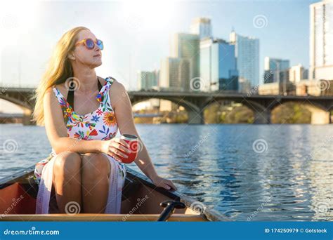 Beautiful Woman On A Summer Day Enjoying A Relaxing Boat Ride On Lake