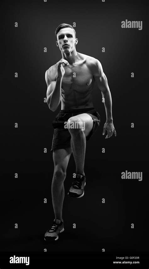 Healthy And Fitness Man Running On Black Background Stock Photo Alamy