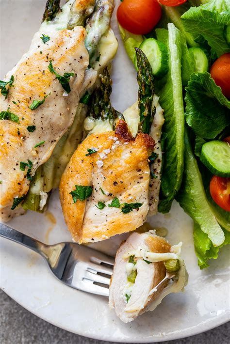 Asparagus stuffed chicken is one of the most impressive dishes you can make with very little effort. Cheesy asparagus stuffed chicken - Simply Delicious