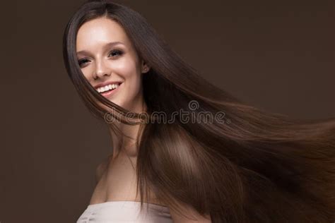 Beautiful Brunette Girl In Move With A Perfectly Smooth Hair And Classic Make Up Beauty Face