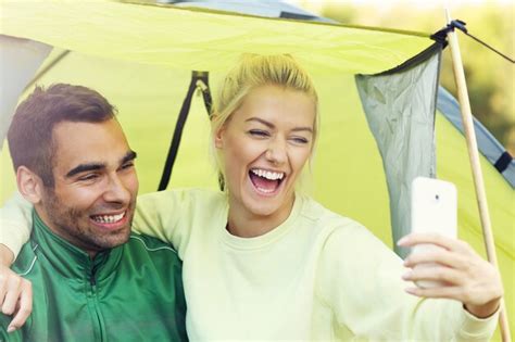Premium Photo Couple Camping In Forest And Taking Selfie