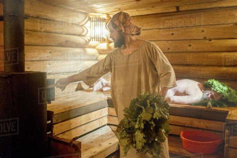 The Bearded Sauna Master Practicing Steam Treatment In Russian Sauna Stock Photo Dissolve