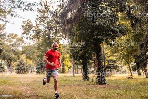 Athlete Man Running In Public Park Stock Photo Download Image Now