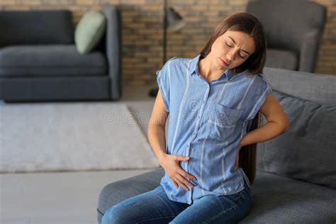 Young Pregnant Woman Suffering From Pain At Home Stock Photo Image Of