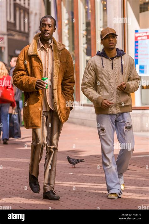 Amsterdam Netherlands Two Men Stroll On Kalverstraat In Downtown
