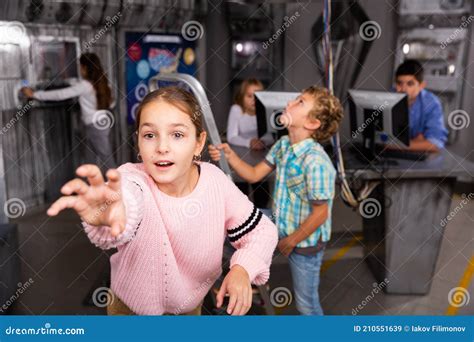 Tween Girl Holding Out Hand To Something In Escape Room Stock Image