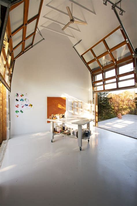 Sectional glass garage doors used in modern designs. NB20º5 / YH2 Architecture | Glass garage door, Interior ...