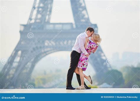 Romantic Couple Kissing Near The Eiffel Tower In Paris France Stock