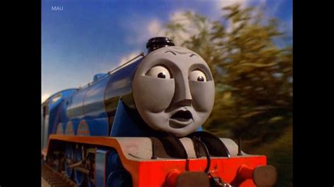 A Thomas The Tank Engine Is Riding On Train Tracks
