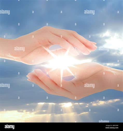 Female Hands Holding Sunlight On Sky Background Stock Photo Alamy