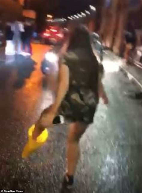 Bizarre Footage Shows Woman Hopping Around Outside Nightclub With A Traffic Cone Stuck On Her