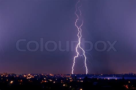 Lightning Strike Over Dark Blue Sky In Night City Stock