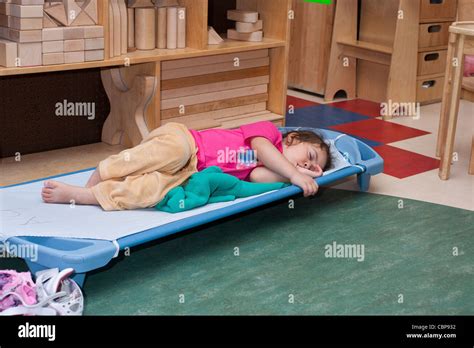4 Year Old Preschool Girl Sleeping On A Cot During Naptime Stock Photo