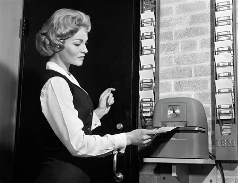 1960s Woman Punching Time Clock At Work Photograph By Vintage Images