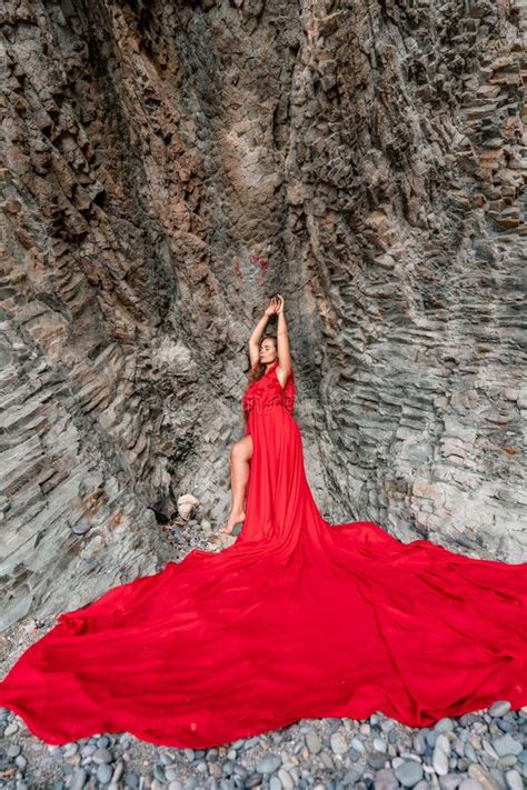 Woman Sea Red Dress Woman With Long Hair On A Sunny Seashore In A Red