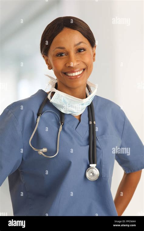 Happy Millennial Female Doctor Smiling Indoors Hospital Corridor Stock