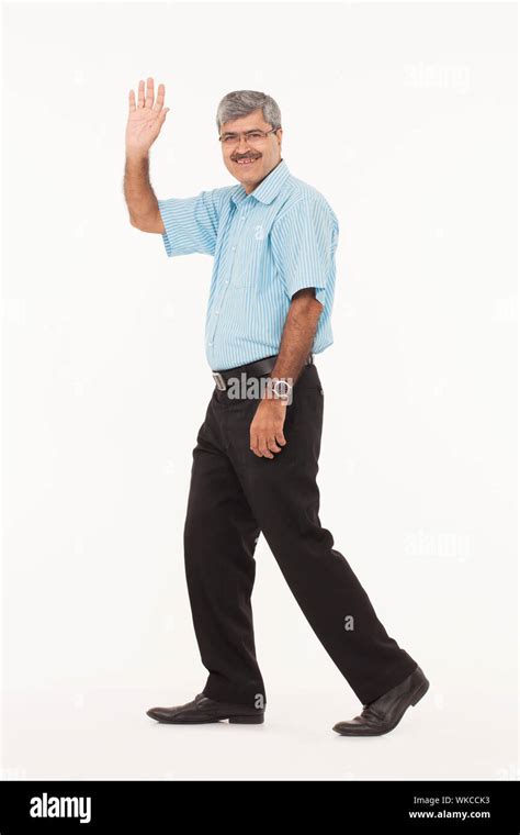 Businessman Walking With Waving Hands Stock Photo Alamy