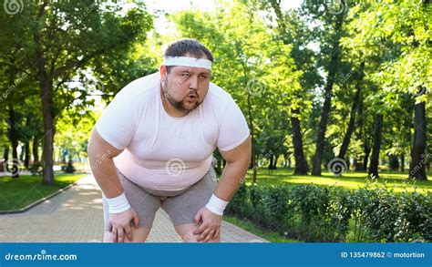 Purposeful Fat Man Running In Park Out Of Breath Persistent