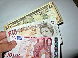 Currency Exchange A Person Holding Three Different