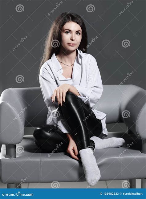 Close Up A Brooding Creative Woman Sitting On An Office Chair Stock