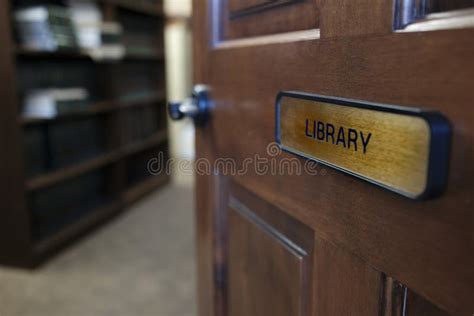 Library Sign On Door Leading To Room With Books On Shelves Stock Image