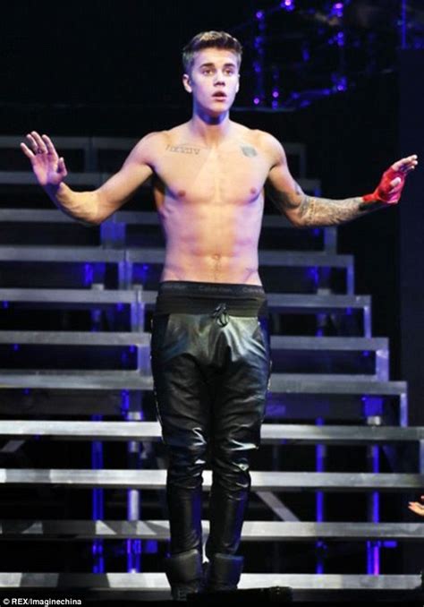 justin bieber whips his jacket off to bare naked chest during beijing concert daily mail online