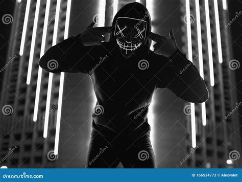 Anonymous Man In Black Hoodie Hiding His Face Behind A Neon Mask Stock Image Image Of Male