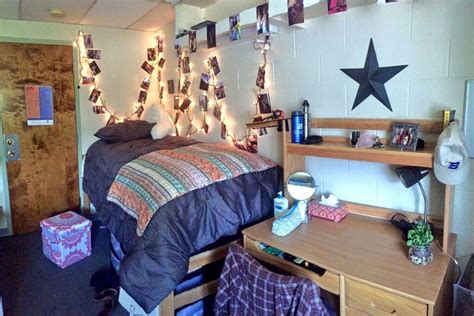 A Dorm Room With Lights Strung From The Ceiling And Decorations On The