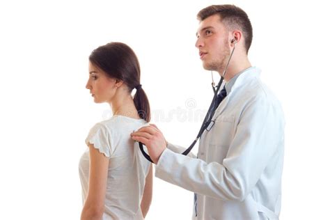 Young Guy Doctor In White Lab Coat Stethoscope Listens Back Female