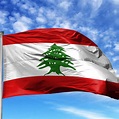 National flag of Lebanon on a flagpole in front of blue sky – Cedar Routes