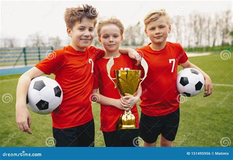 Happy Sports Soccer Team Players Holding Trophy Winners Of Youth