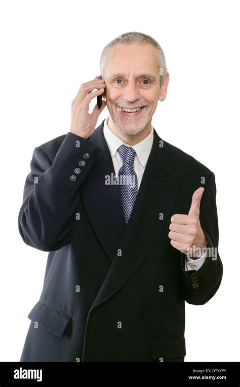 An Amiable Businessman Smiling On Mobile Phone With Thumb Up Stock