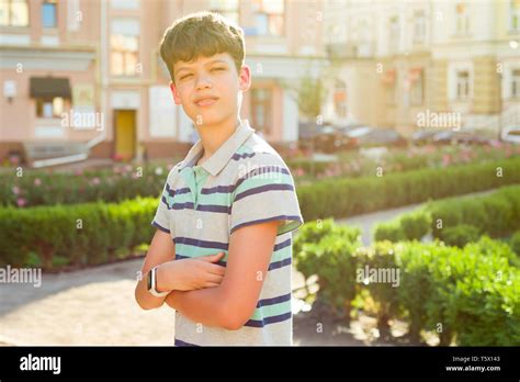 Outdoor Portrait Of Teenager 13 14 Years Old Boy With Crossed Arms
