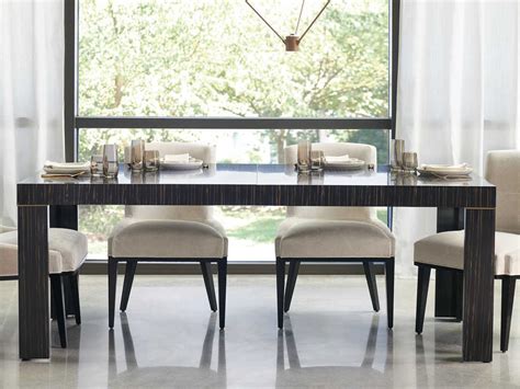 The nald dining table sets itself apart with a solid wood and veneer construction showing off a rich brown cherry finish that adds an inviting touch of warmth, enhanced with antique metal accents around on two pedestal bases. Caracole Modern Edge Striated Ebony / Lucent Bronze ...
