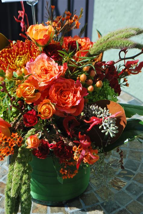 Deep burgundy roses, berries, and seedpods look great in autumn flower arrangements. Free spirit. orange autumn fall centerpiece burgundy ...
